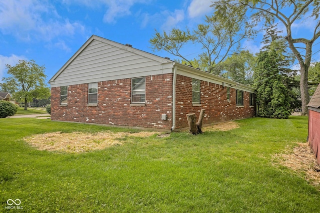 3148 Arbutus Dr, Indianapolis, IN 46224 - view of side of property featuring brick siding and a yard