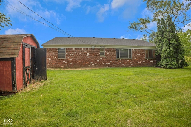 3148 Arbutus Dr, Indianapolis, IN 46224 - back of house with brick siding and a yard