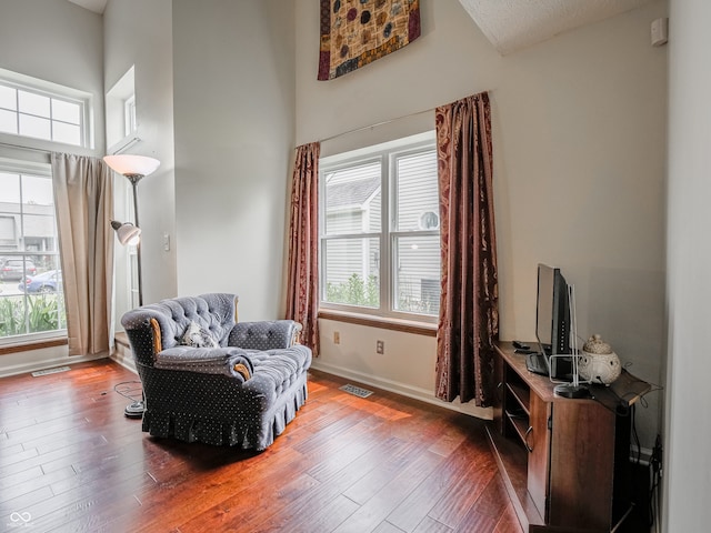 4382 Castlebay Way, Indianapolis, IN 46254 - living area with baseboards, hardwood / wood-style floors, and a high ceiling