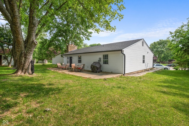 5811 Simmul Cir, Indianapolis, IN 46221 - rear view of property with a patio area, a yard, and a chimney