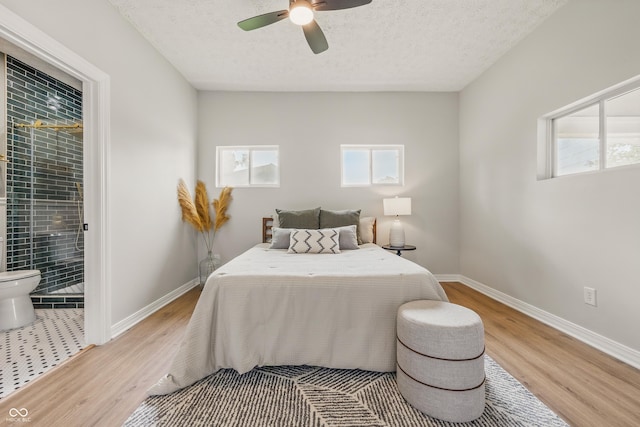 2831 N Talbott St, Indianapolis, IN 46205 - bedroom with light wood-style flooring, baseboards, a textured ceiling, and a ceiling fan