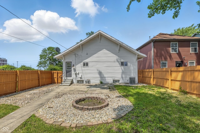 2831 N Talbott St, Indianapolis, IN 46205 - rear view of property with entry steps, a fire pit, central AC unit, and a patio area