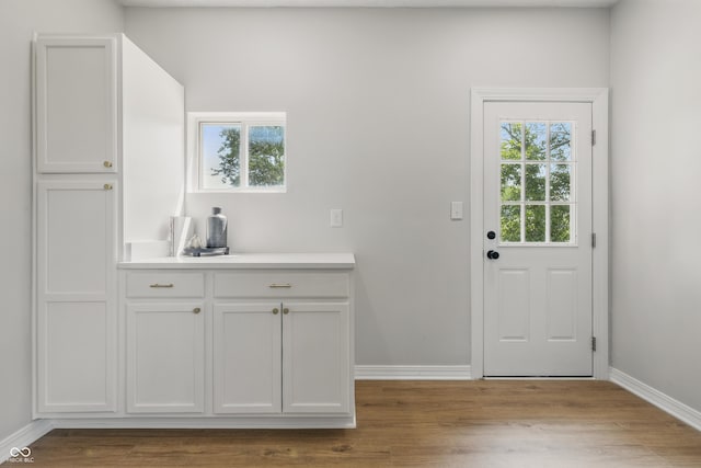 2831 N Talbott St, Indianapolis, IN 46205 - kitchen featuring light countertops, wood finished floors, and baseboards