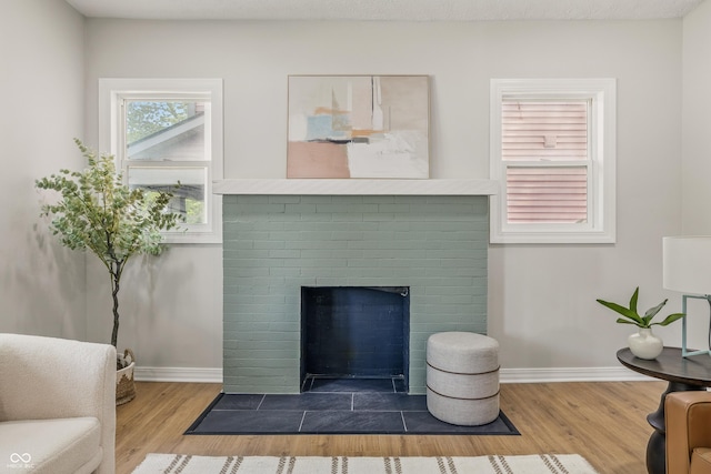 2831 N Talbott St, Indianapolis, IN 46205 - living room featuring wood finished floors, a fireplace, and baseboards