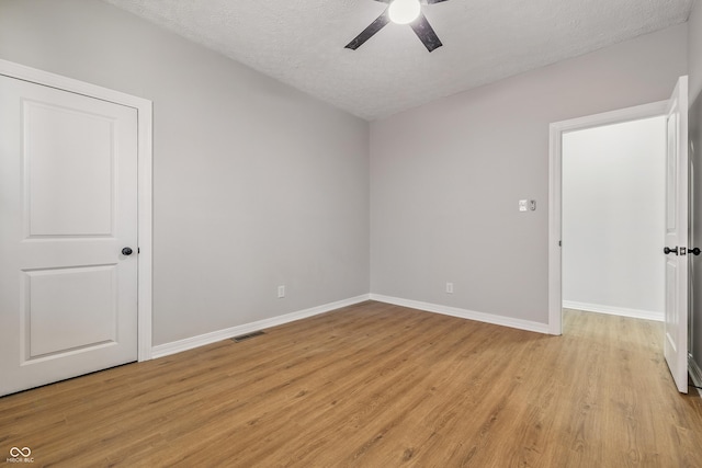 2831 N Talbott St, Indianapolis, IN 46205 - unfurnished room featuring ceiling fan, light wood finished floors, baseboards, and a textured ceiling