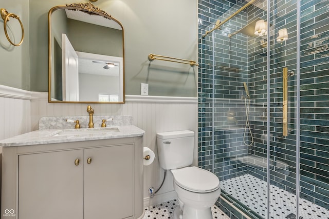 2831 N Talbott St, Indianapolis, IN 46205 - full bathroom featuring a wainscoted wall, vanity, a shower stall, toilet, and tile patterned floors