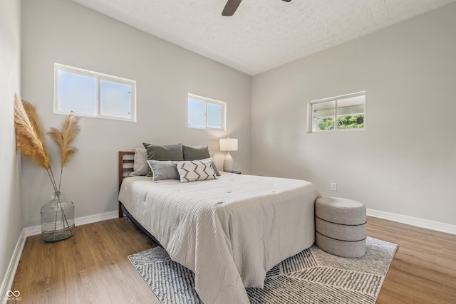 2831 N Talbott St, Indianapolis, IN 46205 - bedroom featuring wood finished floors, baseboards, a ceiling fan, and a textured ceiling