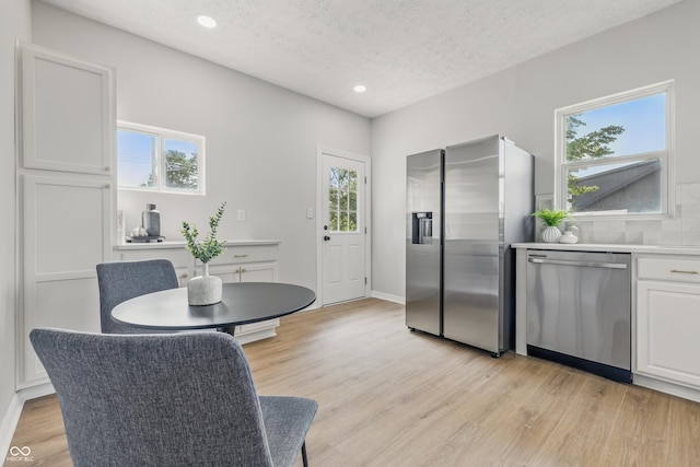 2831 N Talbott St, Indianapolis, IN 46205 - kitchen with stainless steel appliances, light wood-type flooring, recessed lighting, white cabinetry, and a textured ceiling