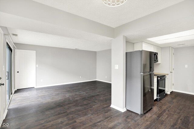 8545 La Corrida Ct, Indianapolis, IN 46227 - kitchen with freestanding refrigerator, black electric range oven, dark wood finished floors, baseboards, and white cabinets