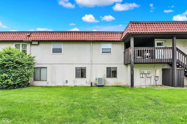 8545 La Corrida Ct, Indianapolis, IN 46227 - back of house featuring cooling unit, stucco siding, a tile roof, and a lawn