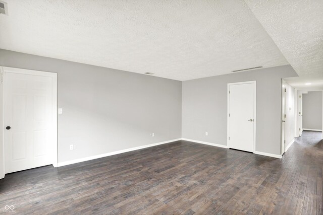 8545 La Corrida Ct, Indianapolis, IN 46227 - spare room with a textured ceiling, dark wood finished floors, and baseboards