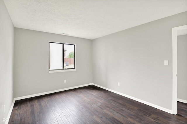8545 La Corrida Ct, Indianapolis, IN 46227 - unfurnished room featuring dark wood-type flooring, baseboards, and a textured ceiling
