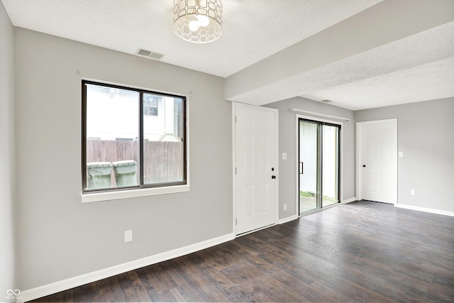8545 La Corrida Ct, Indianapolis, IN 46227 - unfurnished room with healthy amount of natural light, dark wood finished floors, baseboards, and a textured ceiling