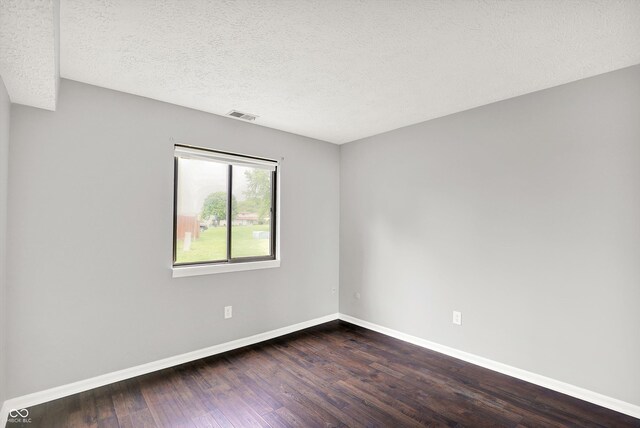 8545 La Corrida Ct, Indianapolis, IN 46227 - spare room featuring dark wood-style floors, baseboards, and a textured ceiling