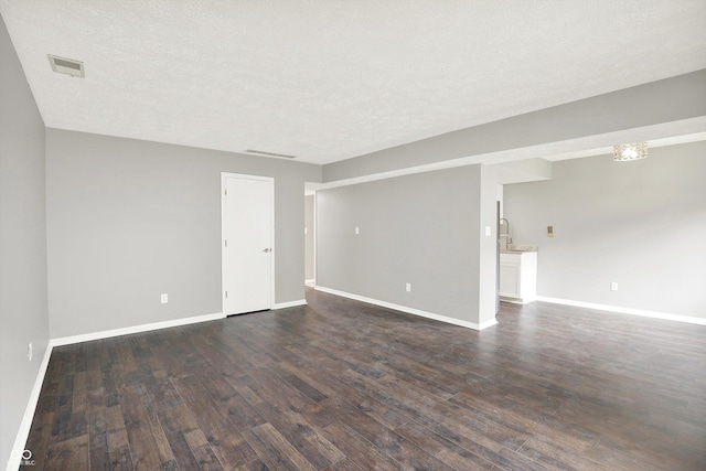 8545 La Corrida Ct, Indianapolis, IN 46227 - unfurnished room with dark wood-type flooring, baseboards, and a textured ceiling