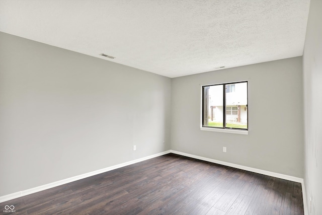 8545 La Corrida Ct, Indianapolis, IN 46227 - empty room featuring baseboards, dark wood-style floors, and a textured ceiling