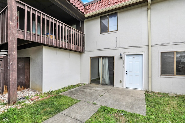 8545 La Corrida Ct, Indianapolis, IN 46227 - back of house with a tiled roof, stucco siding, and a patio