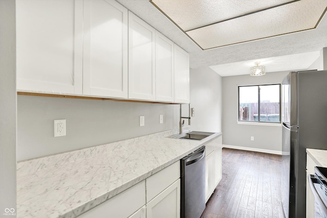 8545 La Corrida Ct, Indianapolis, IN 46227 - kitchen with appliances with stainless steel finishes, white cabinets, dark wood-type flooring, baseboards, and a textured ceiling