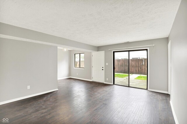 8545 La Corrida Ct, Indianapolis, IN 46227 - unfurnished room featuring dark wood-style flooring, baseboards, and a textured ceiling