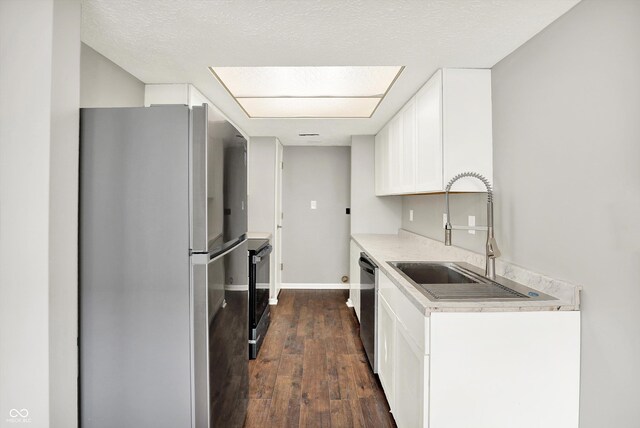 8545 La Corrida Ct, Indianapolis, IN 46227 - kitchen featuring stainless steel appliances, a sink, dark wood-type flooring, light countertops, and white cabinetry