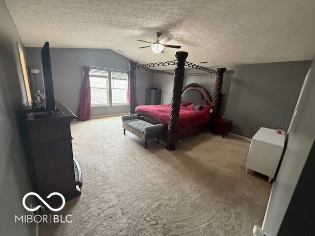 1711 Jaques Dr, Lebanon, IN 46052 - carpeted bedroom with vaulted ceiling, a textured ceiling, a ceiling fan, and baseboards