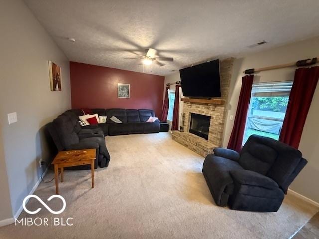 1711 Jaques Dr, Lebanon, IN 46052 - living area with carpet floors, baseboards, a ceiling fan, and a fireplace with raised hearth