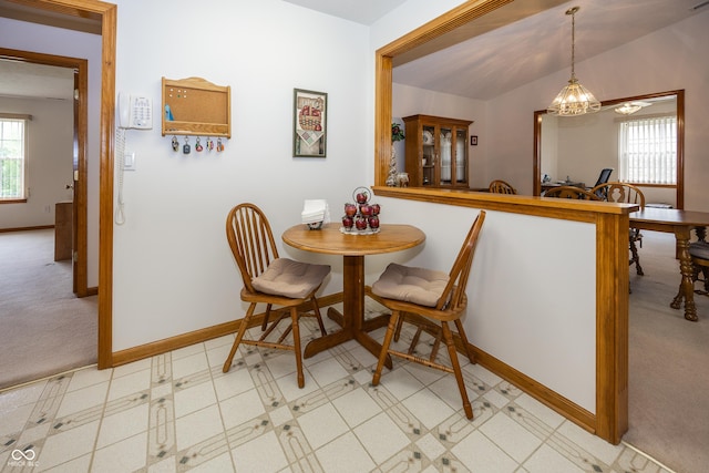 7632 Sea Crest Way N, Noblesville, IN 46062 - dining room with baseboards, light carpet, vaulted ceiling, and a chandelier