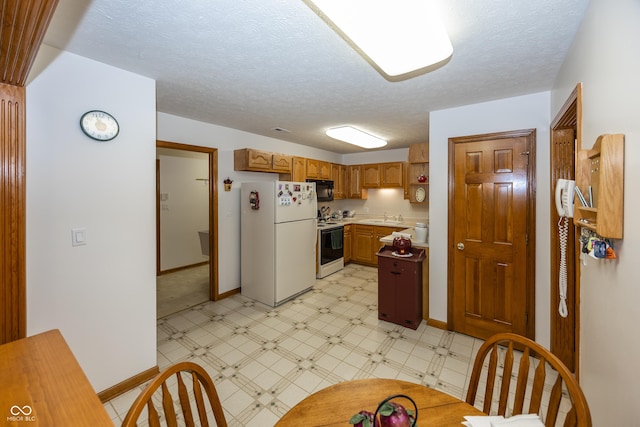 7632 Sea Crest Way N, Noblesville, IN 46062 - kitchen featuring white appliances, a sink, baseboards, light flooring, and a textured ceiling