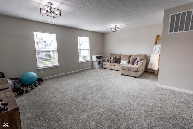 1981 Turning Leaf Dr, Franklin, IN 46131 - living room with a chandelier, carpet flooring, baseboards, and a textured ceiling