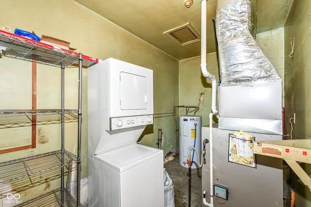 713 W Cromer Ave, Muncie, IN 47303 - washroom featuring stacked washer / drying machine, electric water heater, attic access, and heating unit