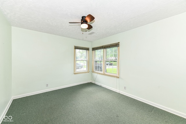 713 W Cromer Ave, Muncie, IN 47303 - spare room featuring dark colored carpet, a ceiling fan, and a textured ceiling