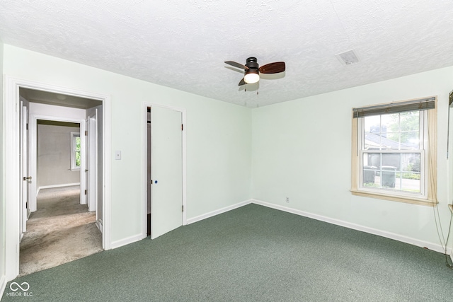 713 W Cromer Ave, Muncie, IN 47303 - unfurnished bedroom with dark carpet, a textured ceiling, and ceiling fan