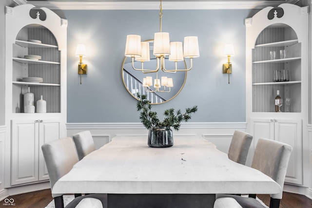 6685 Chapel Xing, Zionsville, IN 46077 - dining room with a chandelier, dark wood finished floors, ornamental molding, a wainscoted wall, and built in shelves