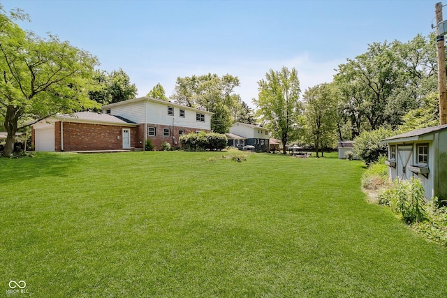6146 Rucker Rd, Indianapolis, IN 46220 - view of green lawn featuring an attached garage