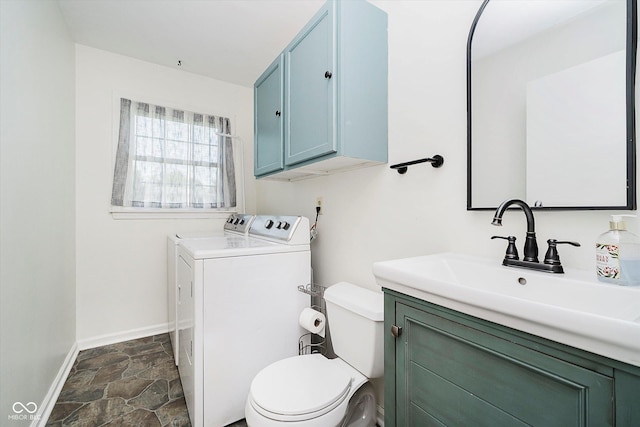 6146 Rucker Rd, Indianapolis, IN 46220 - bathroom with washing machine and dryer, vanity, and stone finish floors