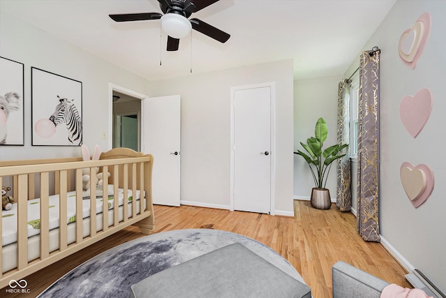 6146 Rucker Rd, Indianapolis, IN 46220 - bedroom featuring wood finished floors, baseboard heating, and a ceiling fan