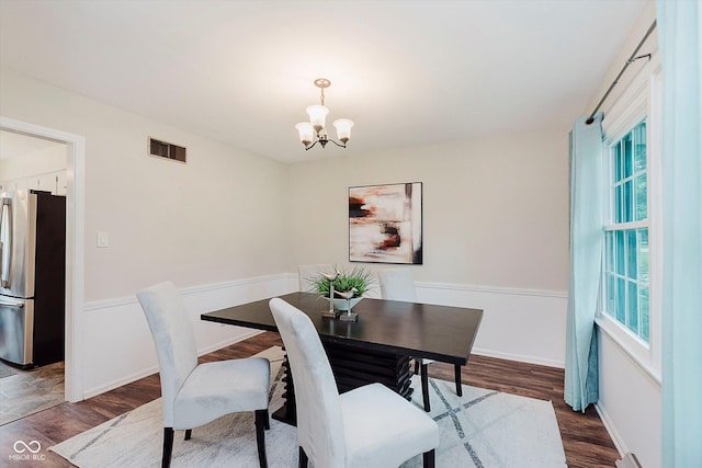 6146 Rucker Rd, Indianapolis, IN 46220 - dining room with a chandelier, plenty of natural light, and wood finished floors