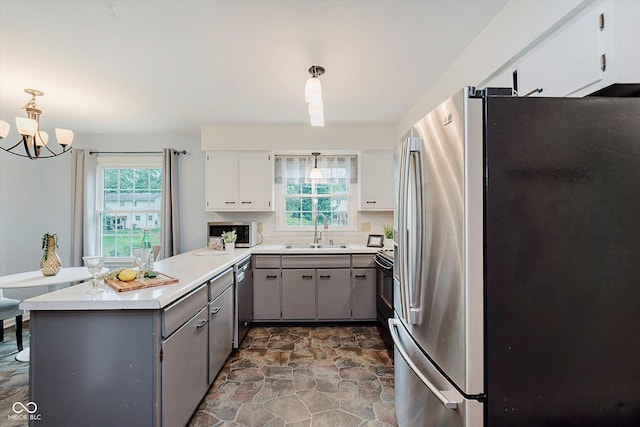 6146 Rucker Rd, Indianapolis, IN 46220 - kitchen featuring stainless steel appliances, gray cabinets, a peninsula, and plenty of natural light