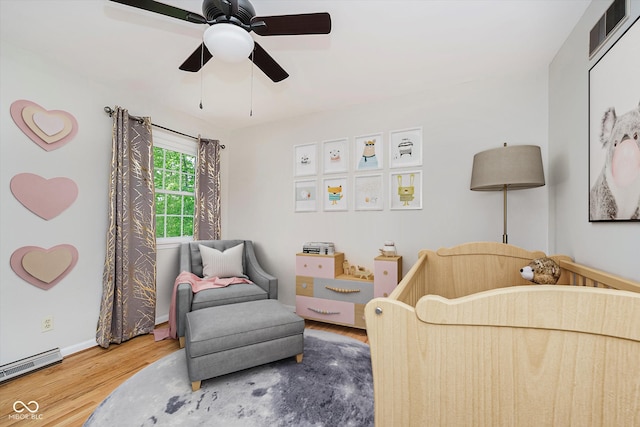 6146 Rucker Rd, Indianapolis, IN 46220 - bedroom featuring wood finished floors, ceiling fan, and baseboard heating