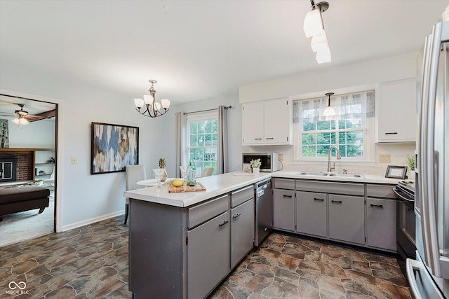 6146 Rucker Rd, Indianapolis, IN 46220 - kitchen featuring gray cabinetry, a peninsula, stainless steel appliances, and dark stone finish floors