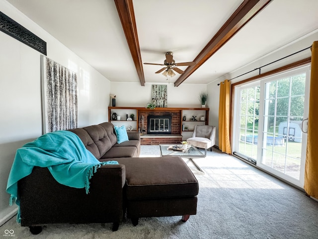 6146 Rucker Rd, Indianapolis, IN 46220 - living room with ceiling fan, beamed ceiling, carpet floors, and a brick fireplace