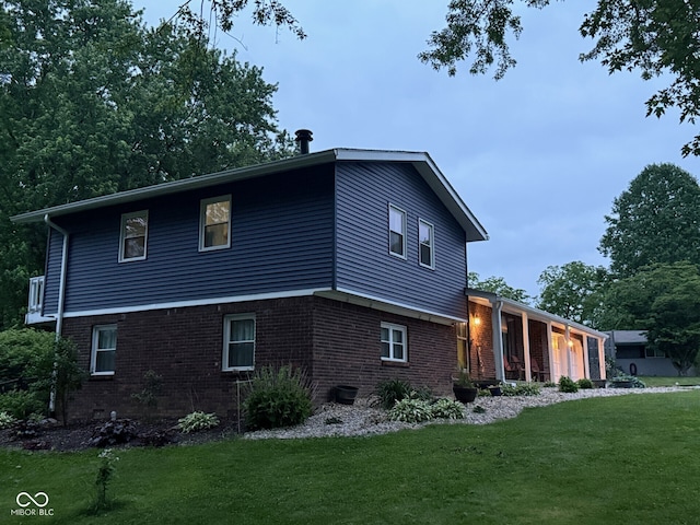 75 Byram Blvd, Martinsville, IN 46151 - view of home's exterior featuring brick siding, an attached garage, and a yard
