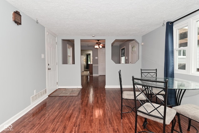 4751 N Longworth Ave, Indianapolis, IN 46226 - dining room featuring wood finished floors, a textured ceiling, a ceiling fan, and baseboards