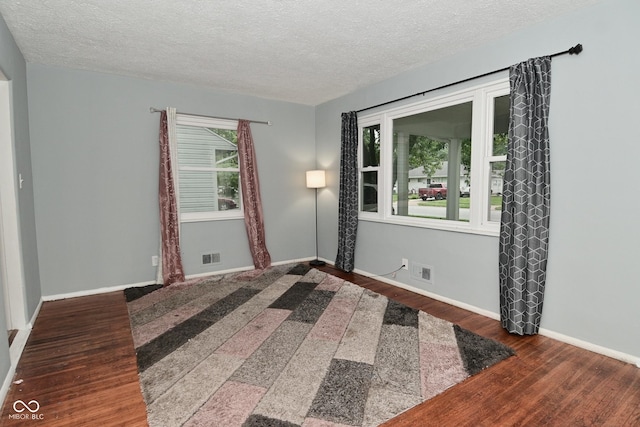 4751 N Longworth Ave, Indianapolis, IN 46226 - spare room featuring wood finished floors, a textured ceiling, and baseboards
