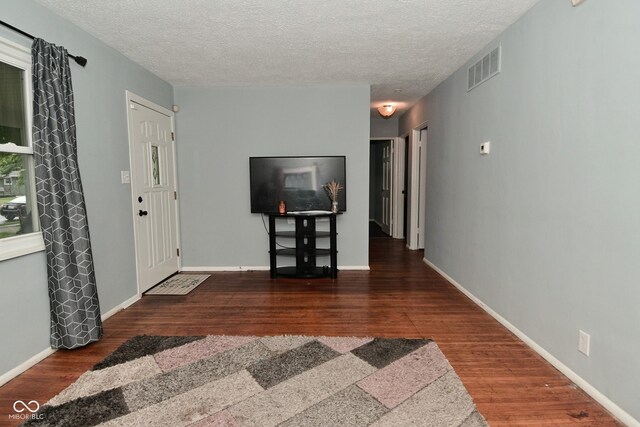 4751 N Longworth Ave, Indianapolis, IN 46226 - entrance foyer with wood finished floors, a textured ceiling, and baseboards