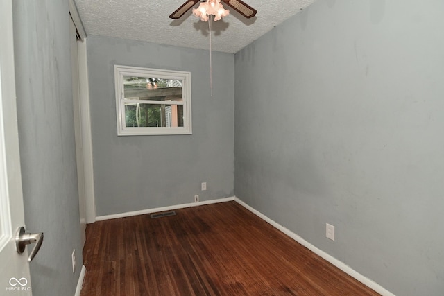 4751 N Longworth Ave, Indianapolis, IN 46226 - unfurnished room featuring dark wood-style floors, a textured ceiling, a ceiling fan, and baseboards