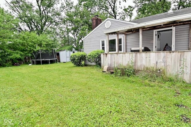 4751 N Longworth Ave, Indianapolis, IN 46226 - view of green lawn featuring a trampoline
