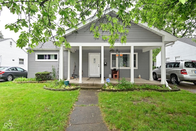 4751 N Longworth Ave, Indianapolis, IN 46226 - bungalow-style home with covered porch and a front lawn