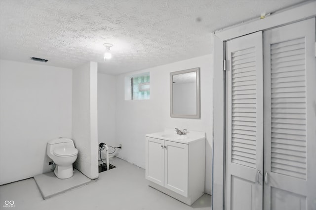 1915 Albany St, Beech Grove, IN 46107 - bathroom with toilet, a closet, vanity, and a textured ceiling