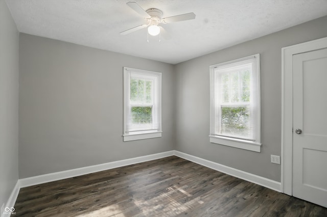 1915 Albany St, Beech Grove, IN 46107 - unfurnished room with dark wood-type flooring, ceiling fan, baseboards, and a textured ceiling